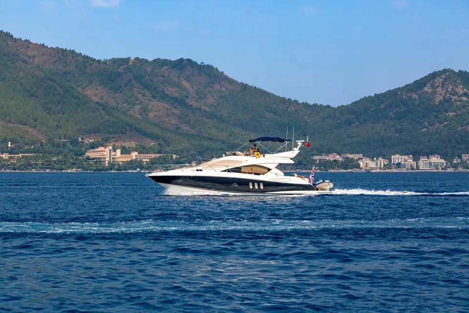 White motor yacht cruising along the Marmaris coast